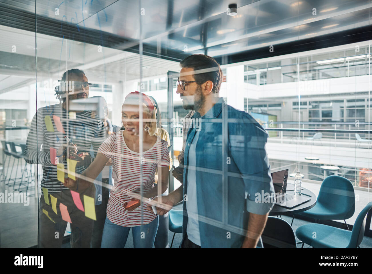 Group of diverse businesspeople using sticky notes during a ...