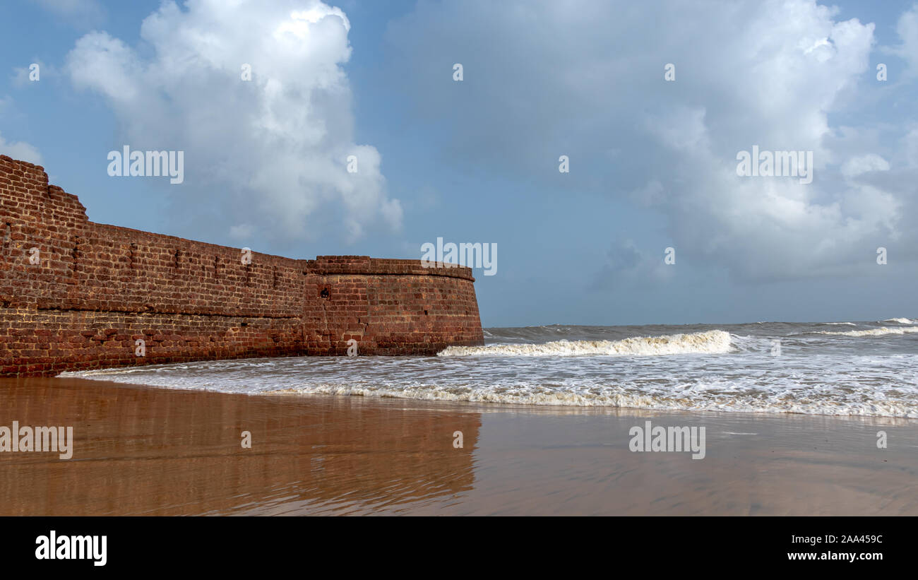 Old ruins of Fort Aguada on the seashores of Goa with sky and clouds Stock Photo