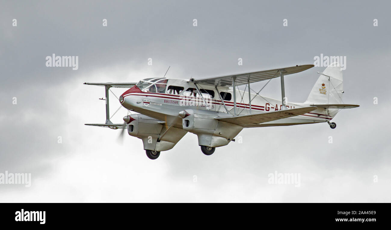 DH-89A Dragon Rapide 6 G-AGSH in flight at Old Warden Aerodrome, Bedfordshire Stock Photo