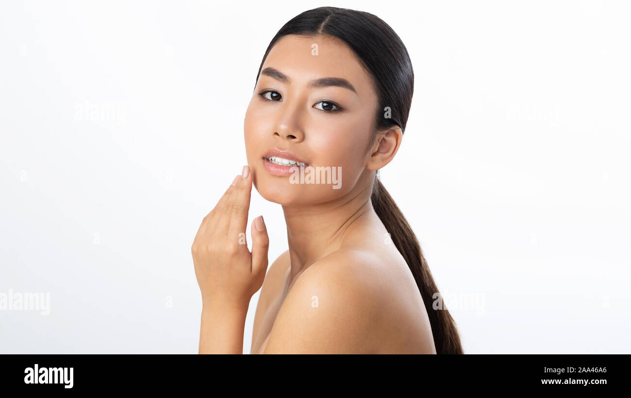 Face lifting concept. Young woman touching soft smooth skin Stock Photo ...