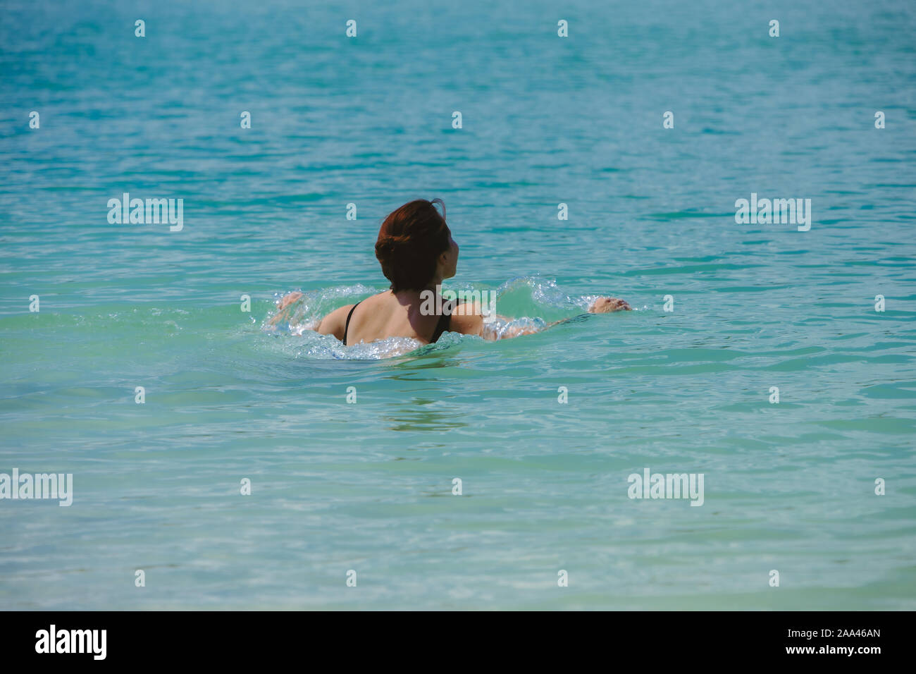 Woman swimming in azure blue hi-res stock photography and images - Alamy