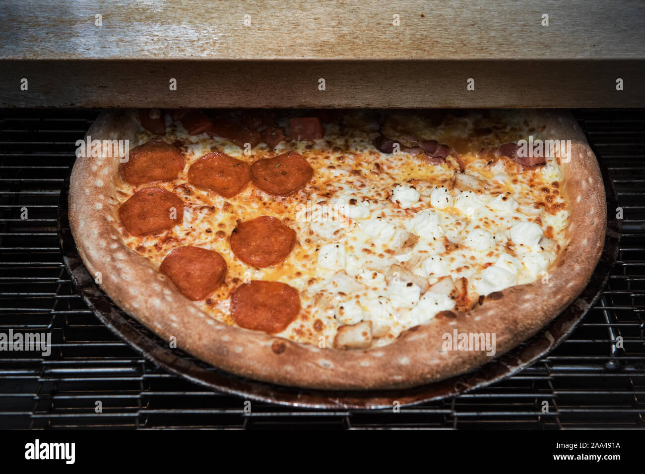 Preparing pizza in oven Stock Photo Alamy