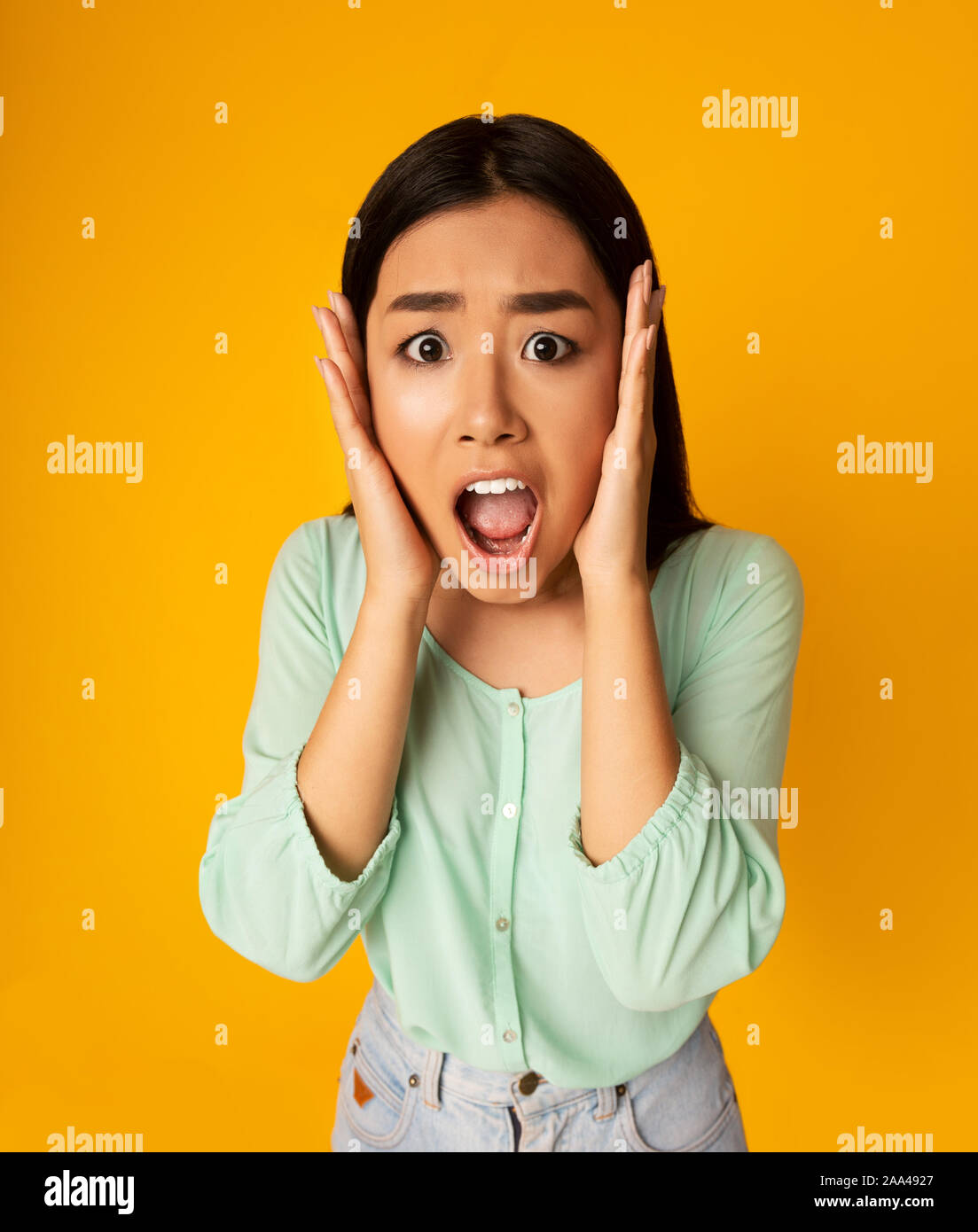 Girl with hands on cheeks hi-res stock photography and images - Alamy