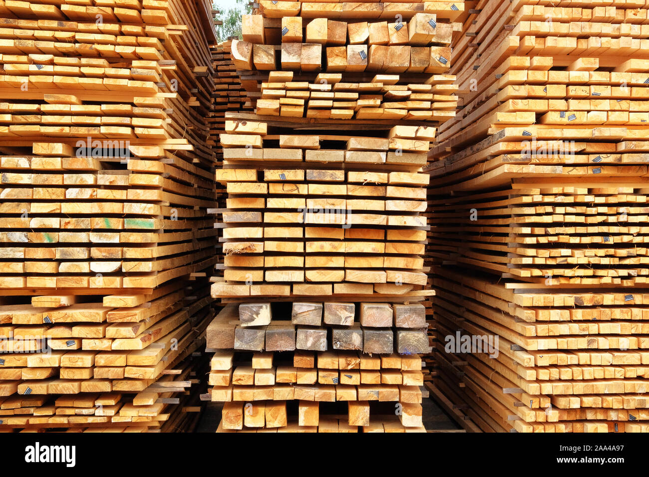 Stack of wooden bars. Pile of new wooden boards on a storage. Stock Photo