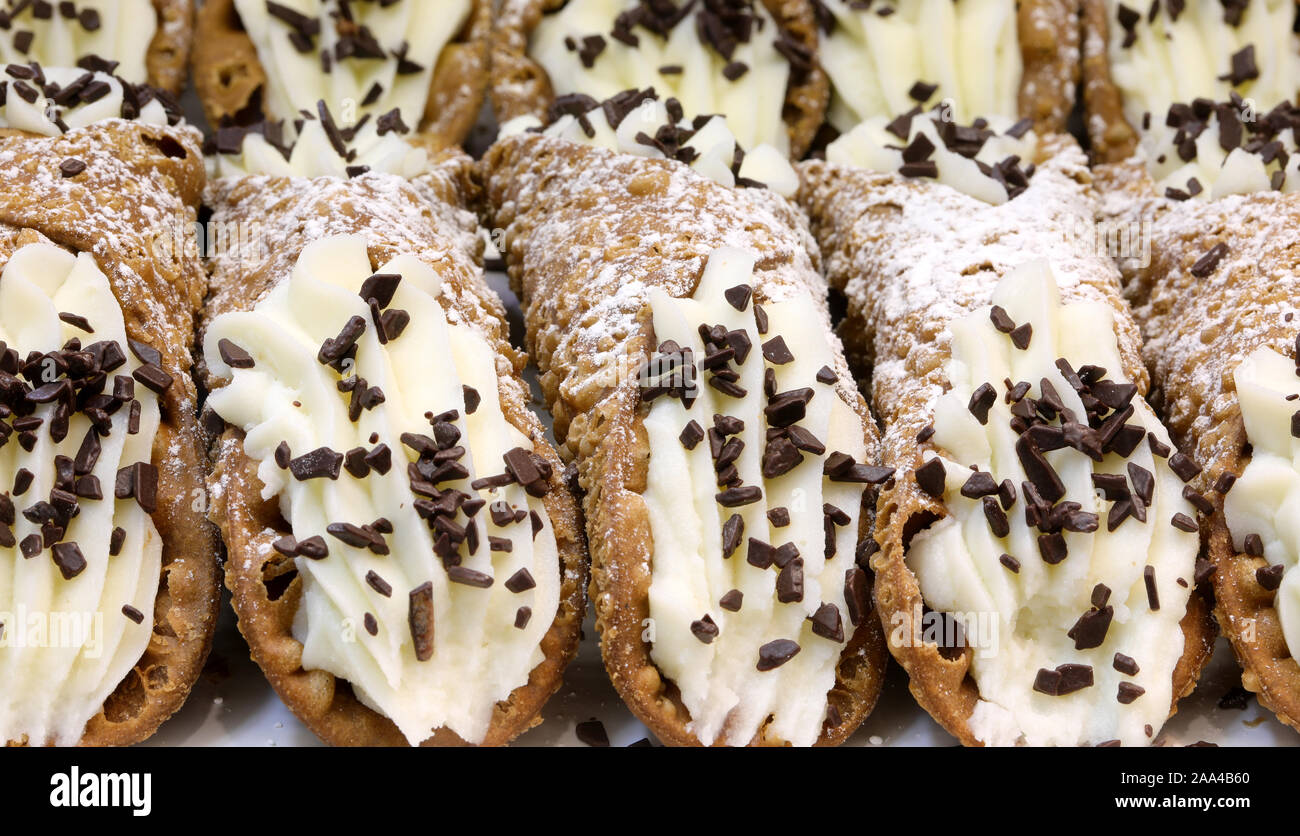 background of many pastry items called Sicilian Cannoli typical cake of Palermo and Sicily in Italy Stock Photo