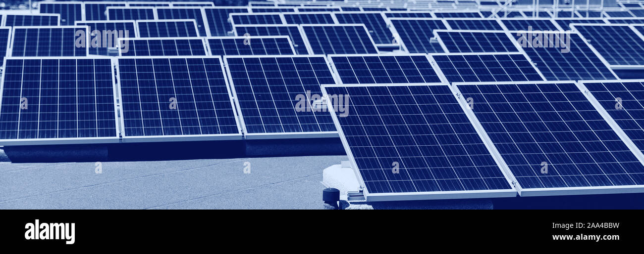 Set of solar panels mounted on roof of building. Renewable energy eco ...