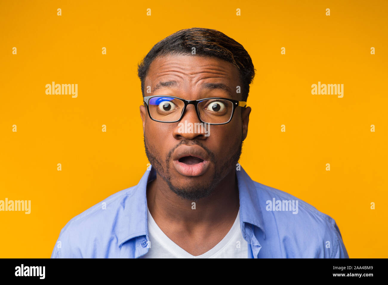 Surprised African American Guy Looking At Camera Posing, Yellow