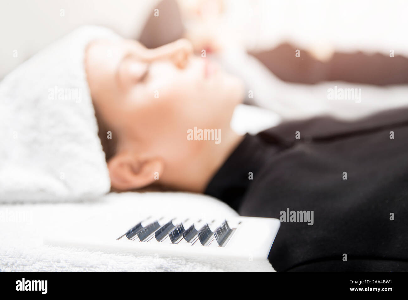 Eyelashes extensions. Lash extension procedure in spa beauty salon