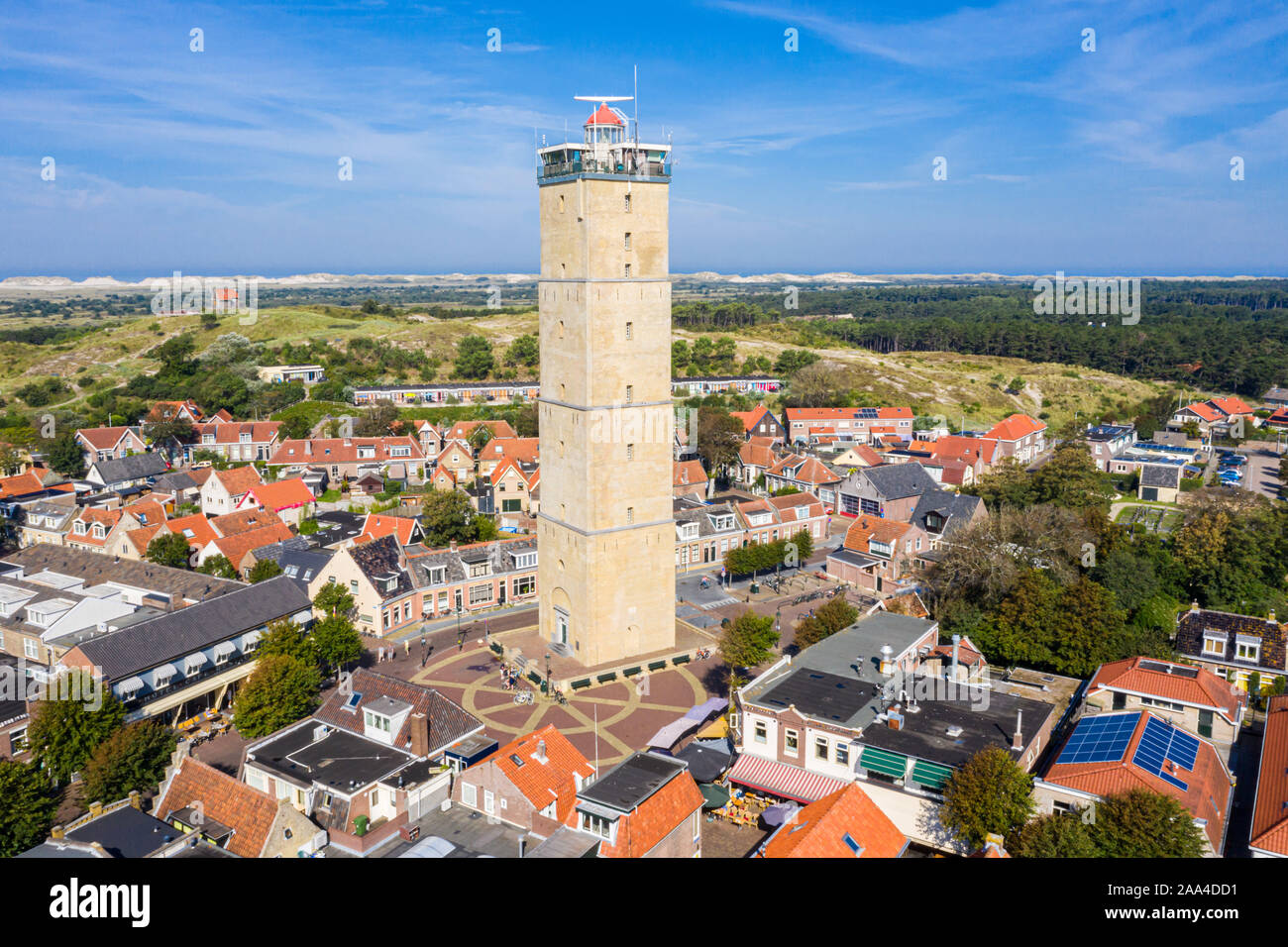 The tower of old Brandaris lighthouse among historical houses around the central square of West-Terschelling town. Terschelling island, West Frisian I Stock Photo