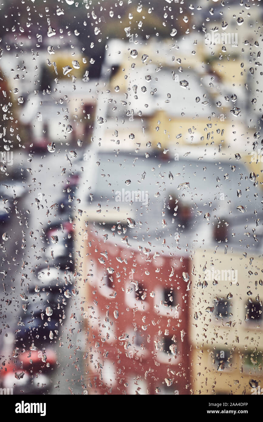 Raindrops on a window glass, color toning applied, selective focus. Stock Photo