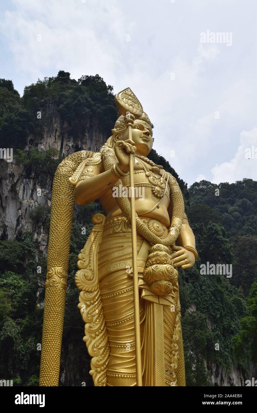 The Gold Statue of Lord Murguan in Batu Caves, a Hindu Shrine in Selangor, Malaysia Stock Photo