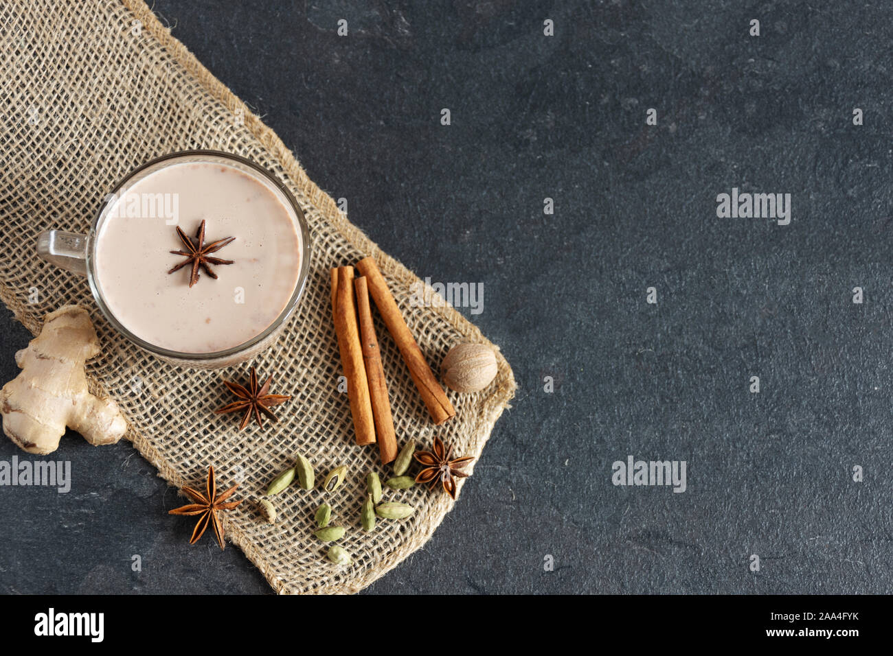 Masala chai made by brewing black tea with aromatic spices, such as Cinnamon Stick, Thai Cardamom, Ginger, Star Anise, Black Peppercorns, Nutmeg. Glas Stock Photo
