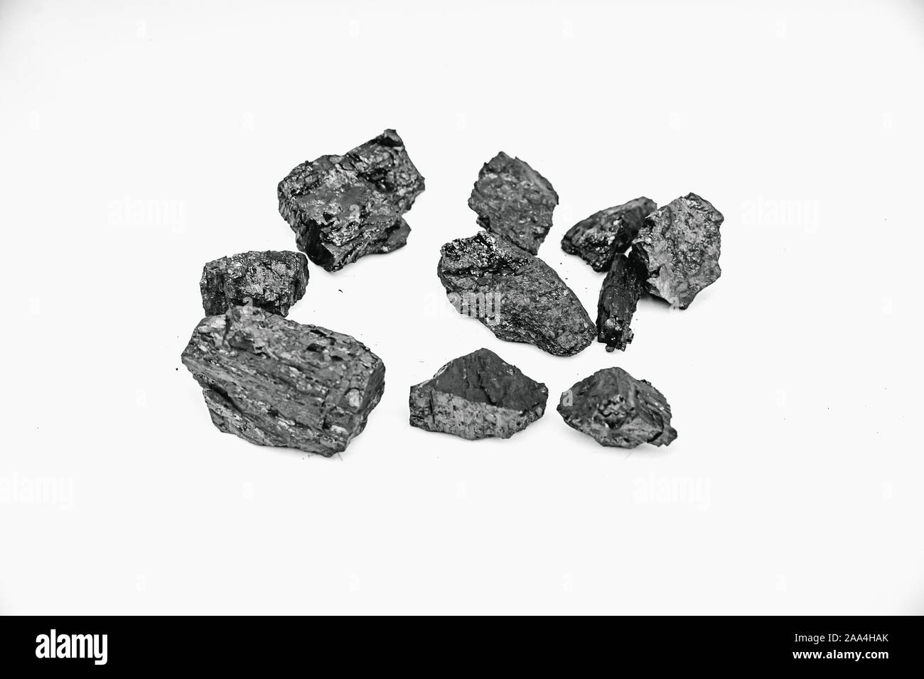 Pieces black coal lie on white isolated background, copy space. Stock Photo