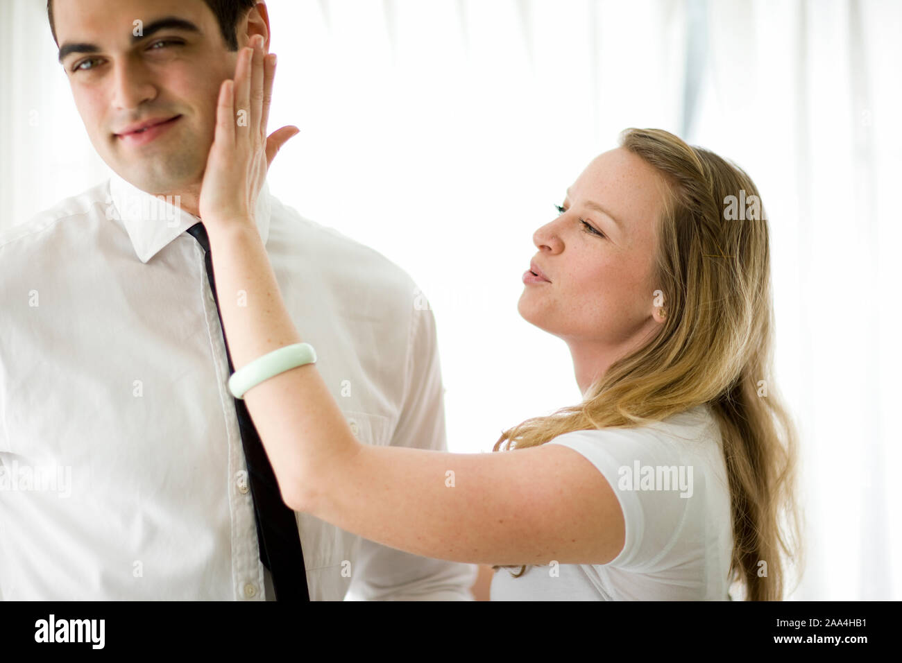 Woman wiping lipstick off man's cheek after a kiss Stock Photo Alamy