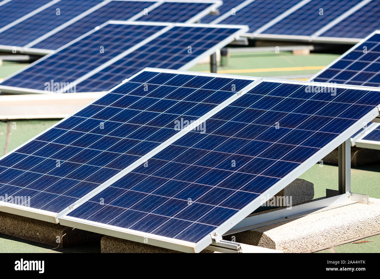 Set of solar panels mounted on roof of building. Renewable energy eco ...