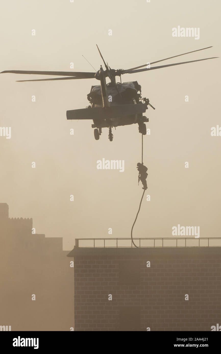 Military combat and war with helicopter flying into the chaos and ...