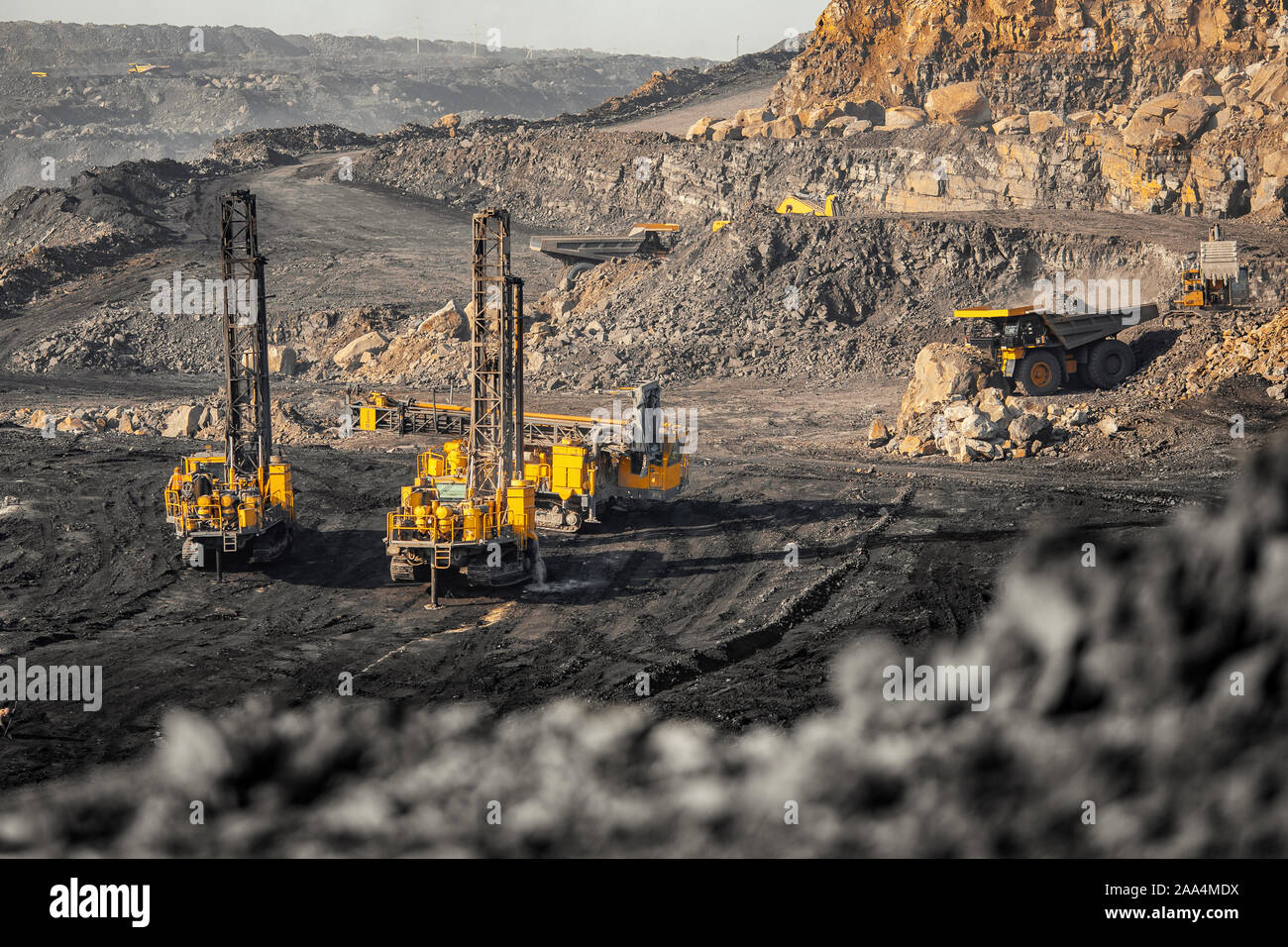 Drilling machine borer installing cast explosives blasting. Open coal
