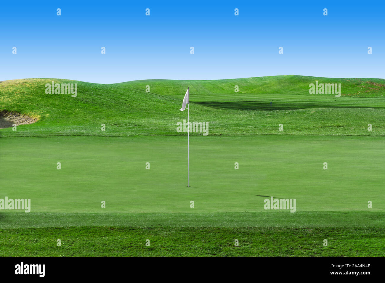 White flag on a golf course with blue sky Stock Photo