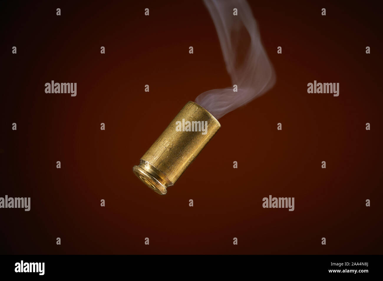 smoking bullet casing fired out of a handgun falling down Stock Photo -  Alamy