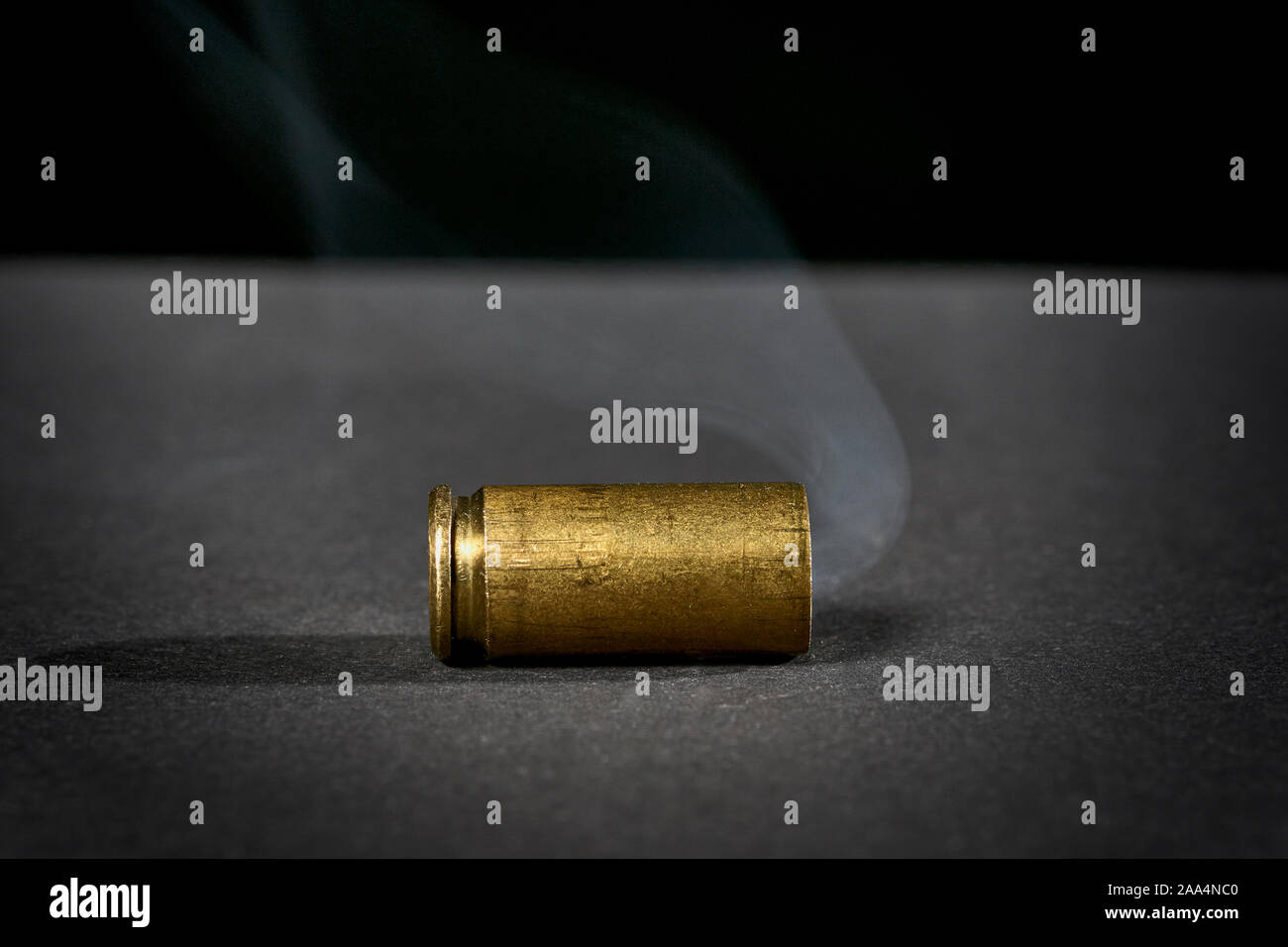 smoking bullet casing fired out of a handgun dropped on the ground Stock  Photo - Alamy