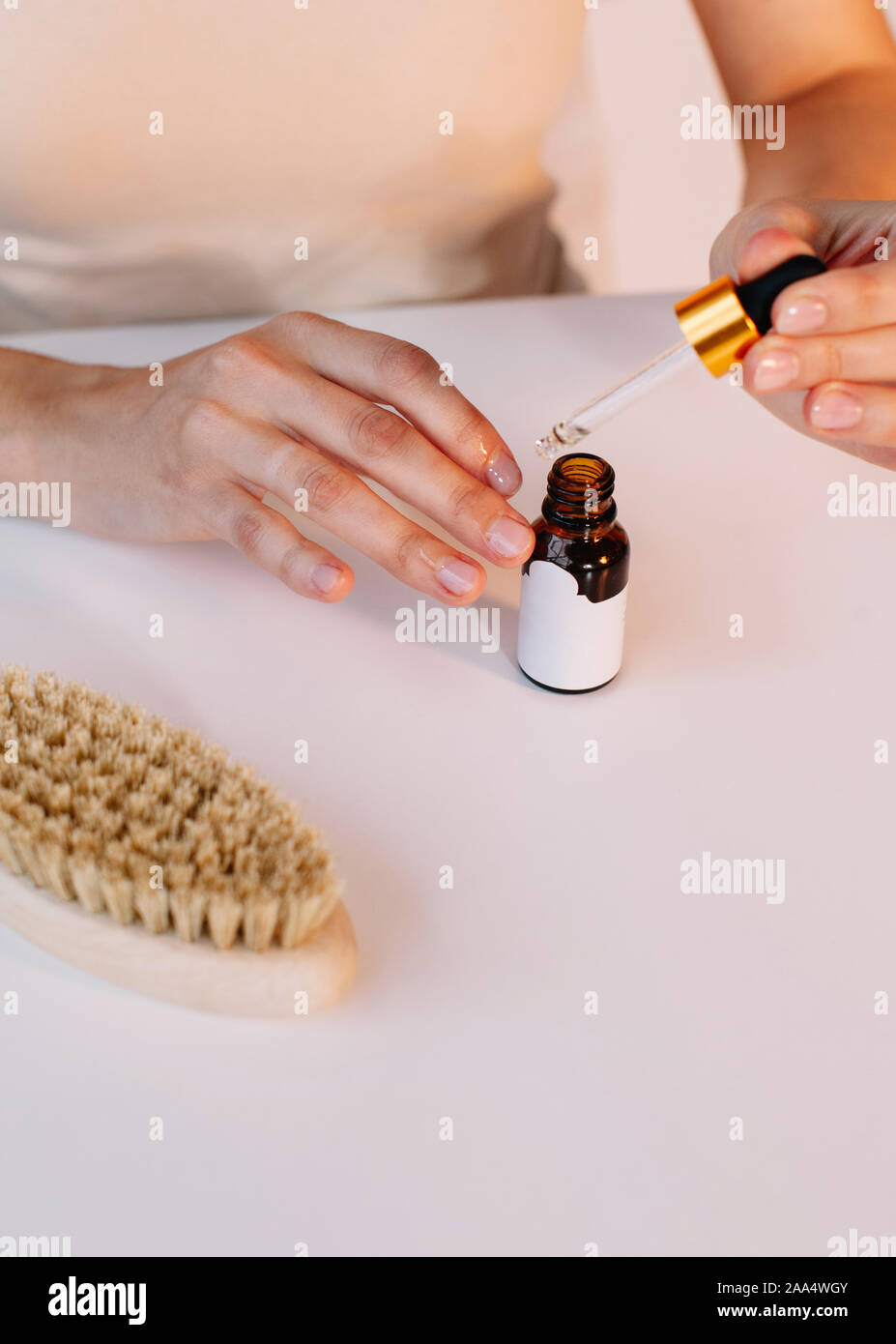 Woman applying cuticle oil to her nails Stock Photo