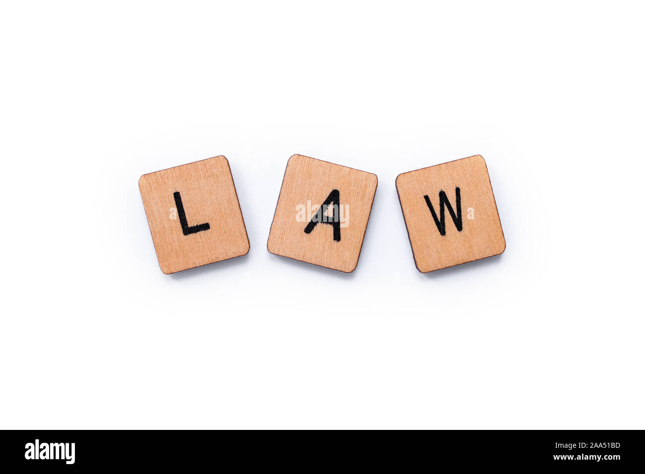 The Word LAW Spelt With Wooden Letter Tiles Over A White Background 