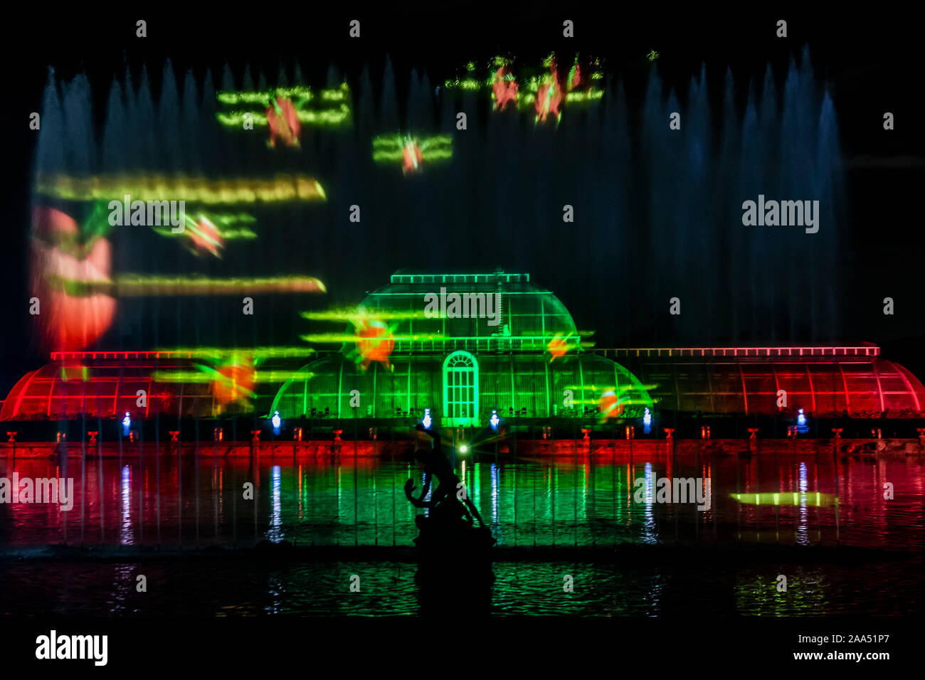London, UK. 19th Nov, 2019. The Palm House finale with festive projections playing across a giant screen of water in the centre of the lake, and across the iconic glasshouse itself. - Christmas at Kew - the annual festive display of seasonal lights in Kew Gardens. It runs from 20 November 2019 - 5 January 2020 Credit: Guy Bell/Alamy Live News Stock Photo