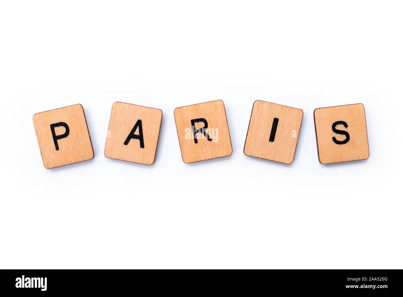 The word PARIS, spelt with wooden letter tiles over a white background. Stock Photo