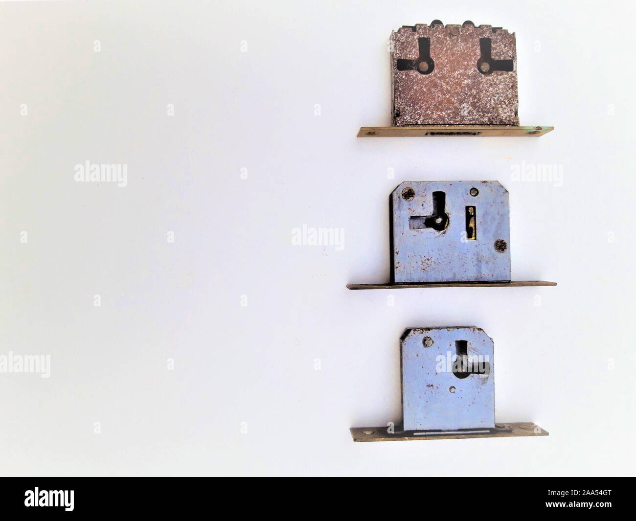 Three rusty locks on white background Stock Photo - Alamy