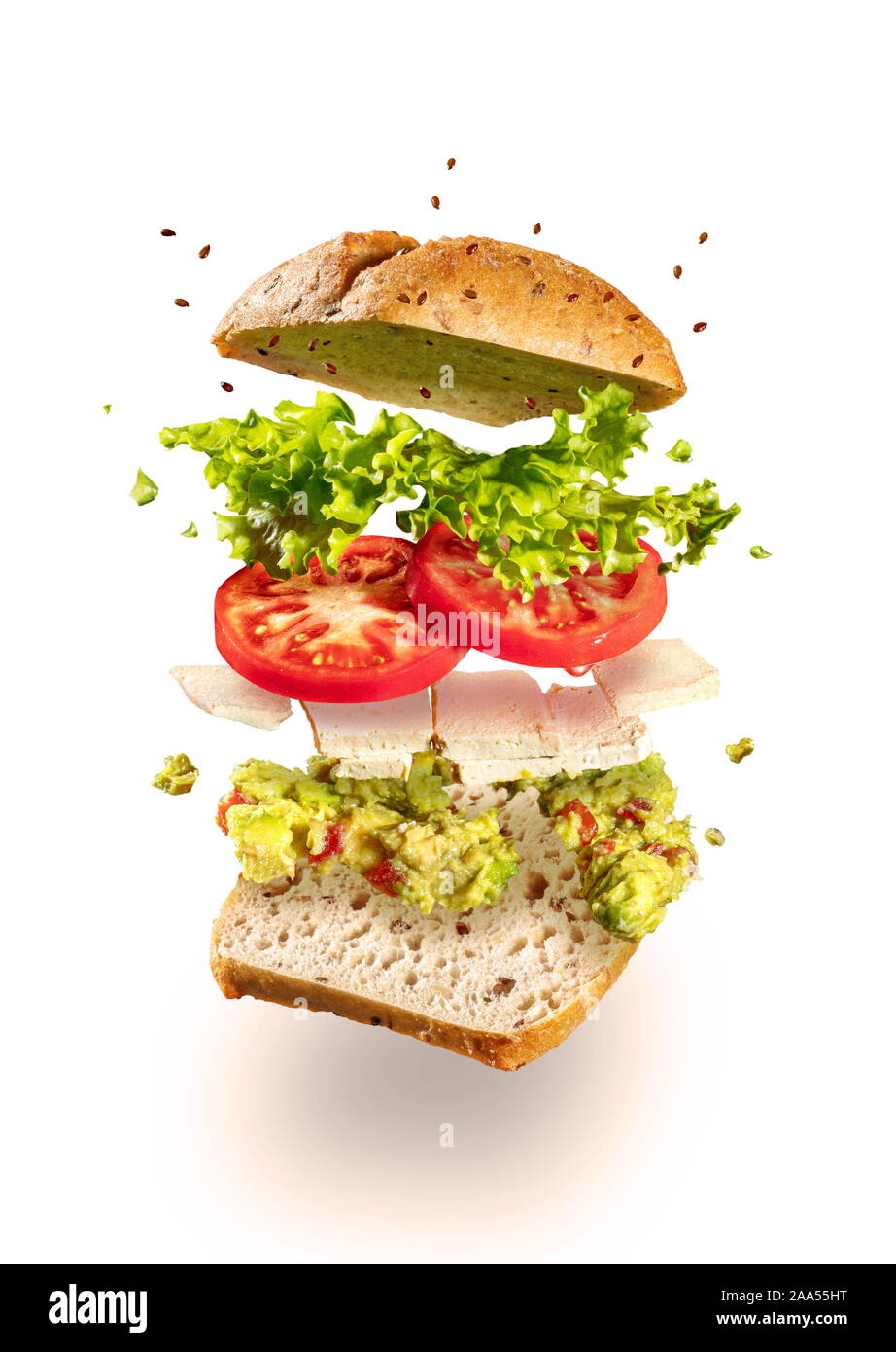 Exploded and flying vegetarian sandwich with guacamole and tofu cheese on white Stock Photo
