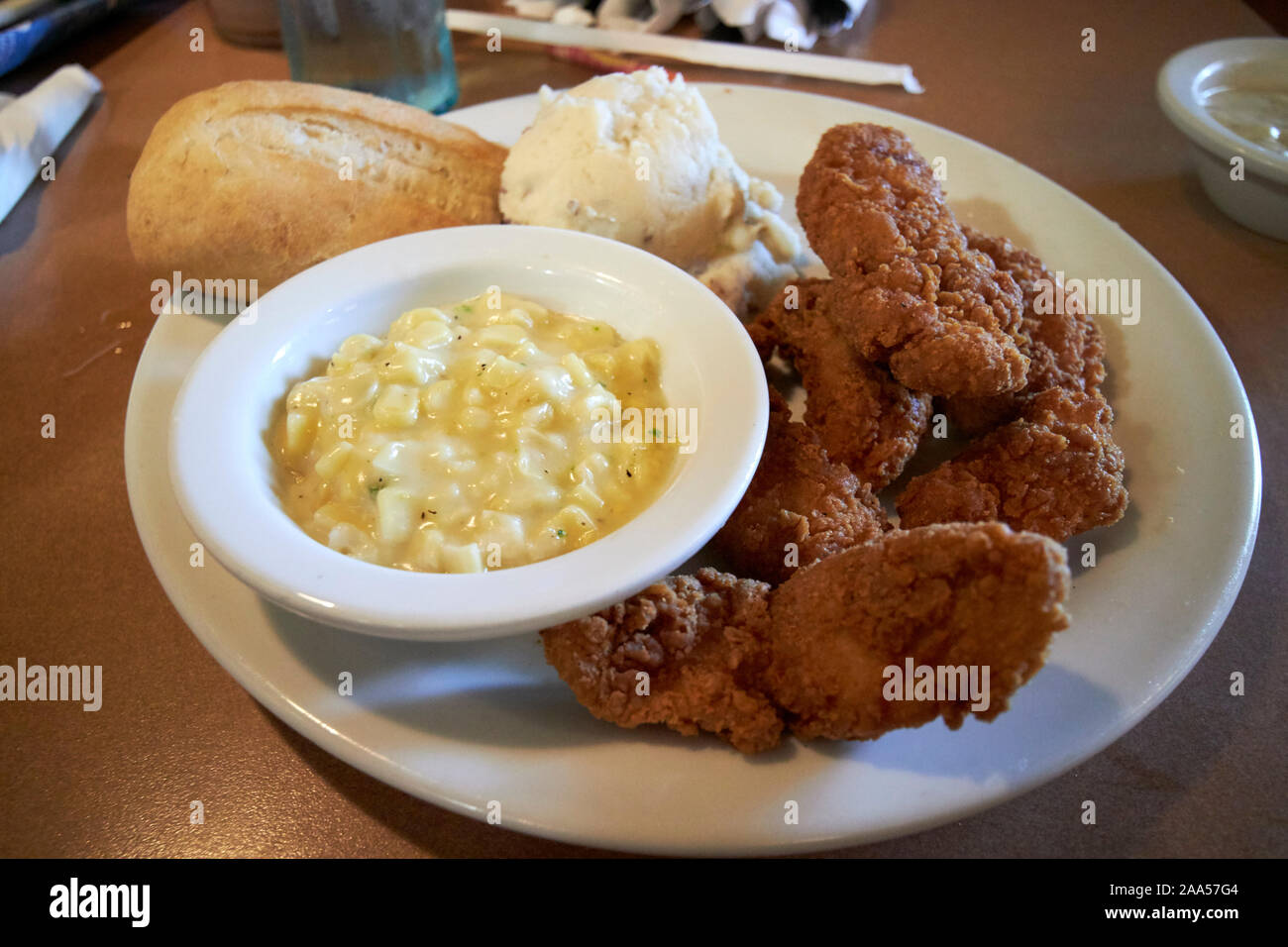 southern fried chicken creamed corn potatoes and bread meal served at