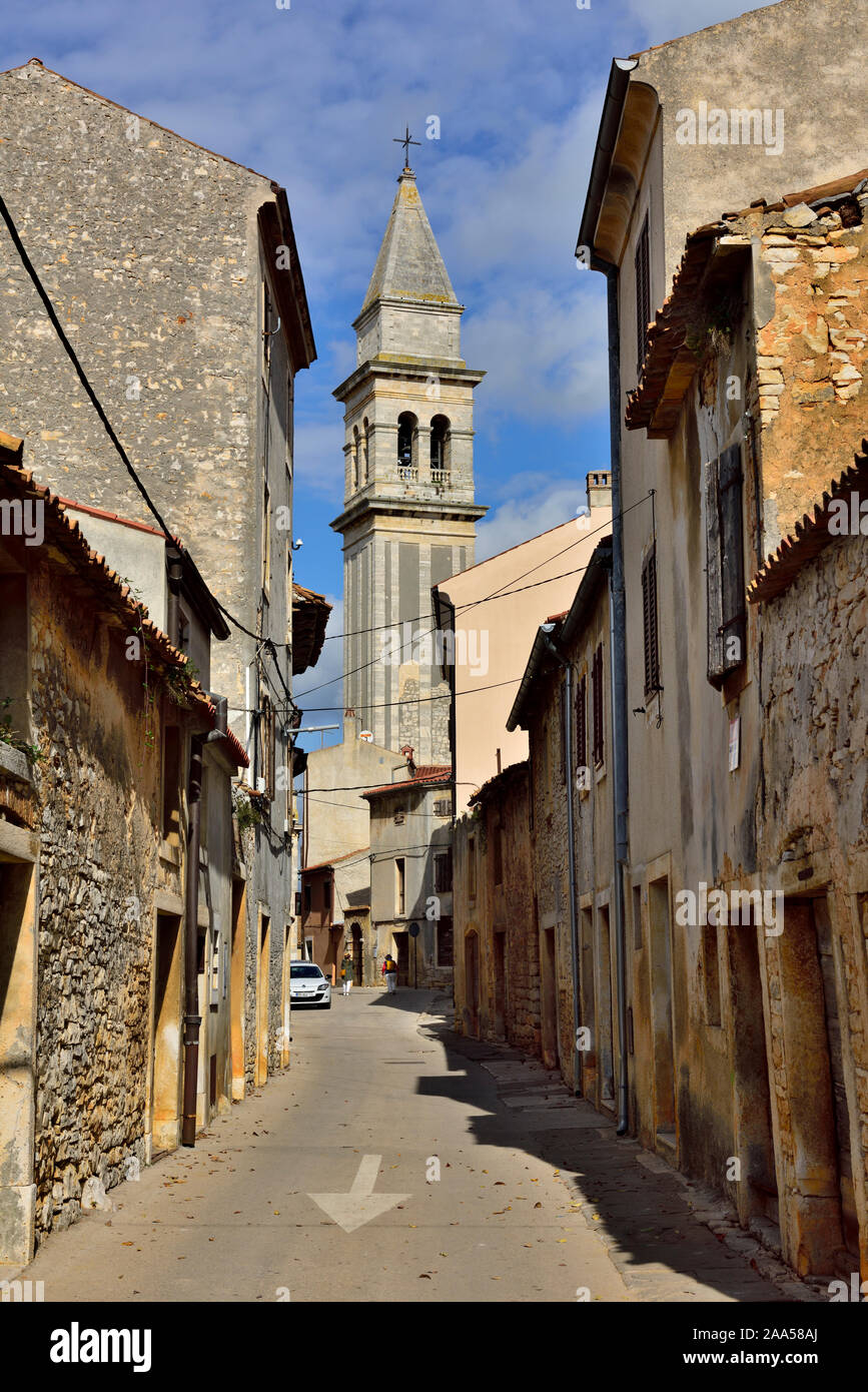 Small side street (Castello ul) in small town of Vodnjan with the church of St. Blaze bell tower in distance, Istria, Croatia Stock Photo