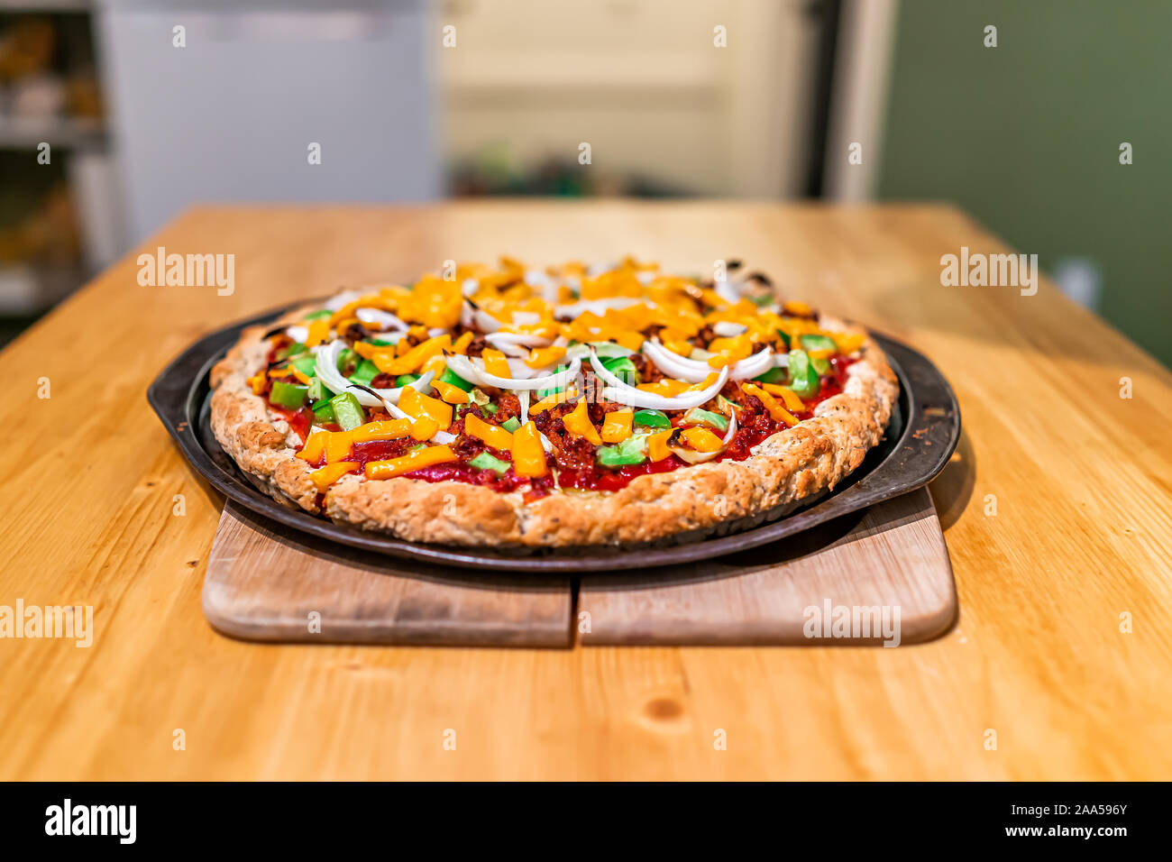 Homemade cooked pizza with tomato sauce and toppings green bell peppers