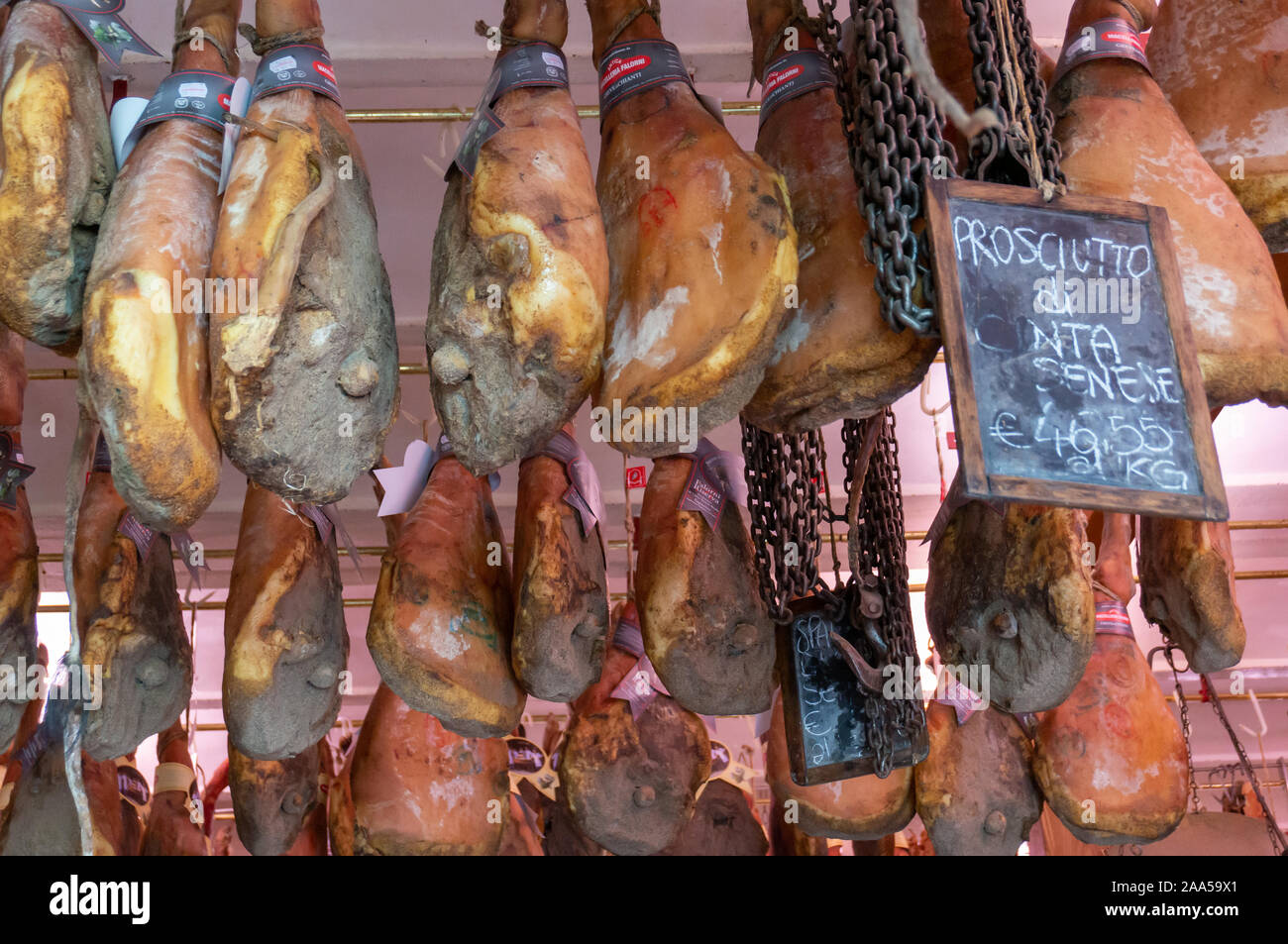 Prosciutto hanging from shop ceiling, Greve in Chianti, Tuscany, Italy