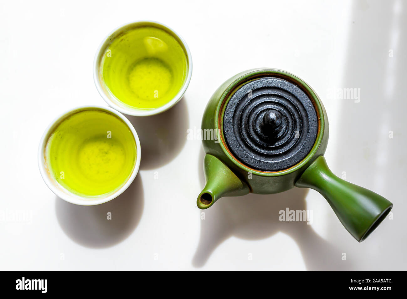 Green clay teapot with kyusu handle flat top flat lay view down on