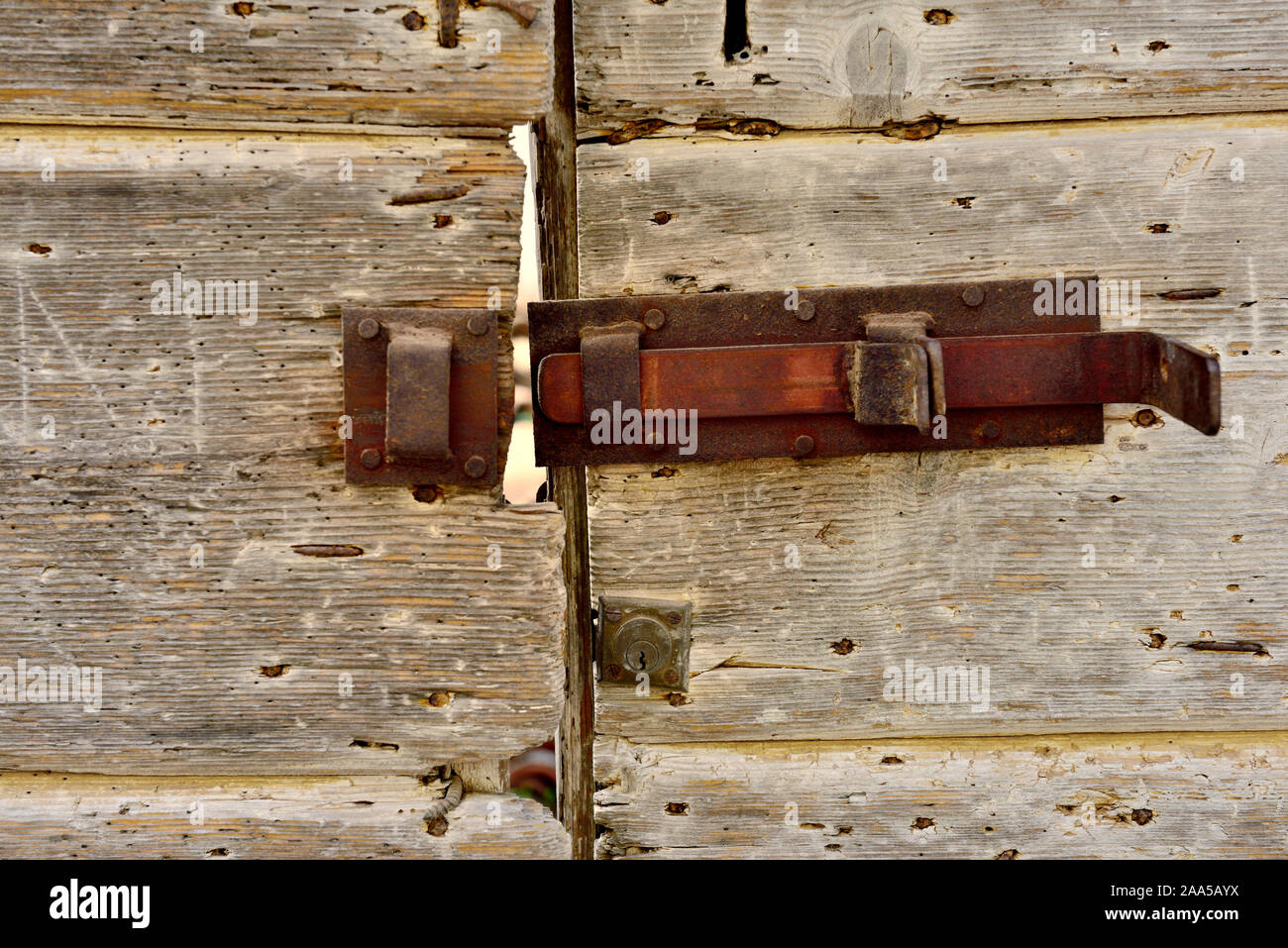 Old wooden door with rusty lock Stock Photo - Alamy