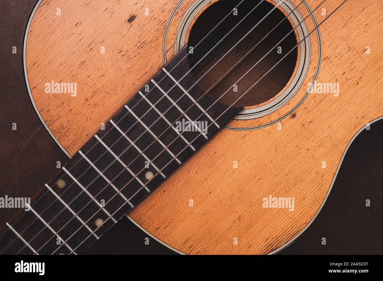 High angle view vintage old fashioned acoustic guitar body wooden neck and soundboard Stock Photo