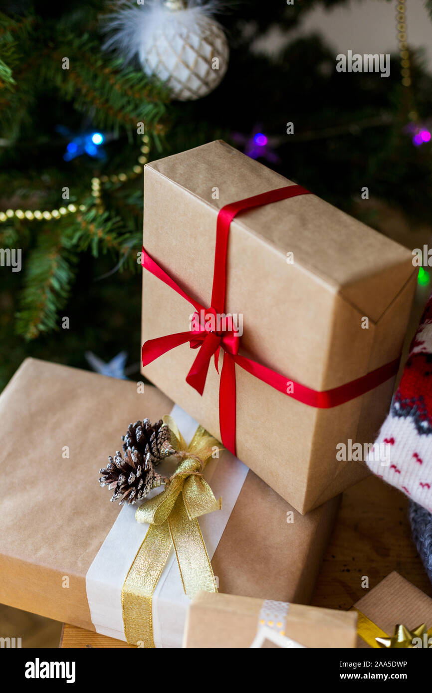 Gift boxes with christmas tree at background. Concept of presents for family for Christmas holidays Stock Photo