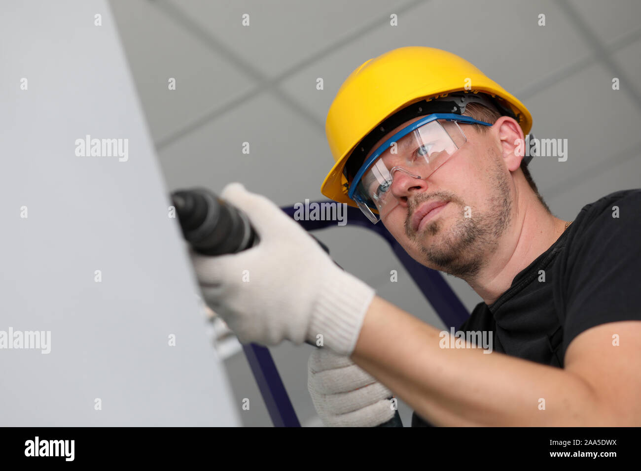 Worker with drilling machine Stock Photo