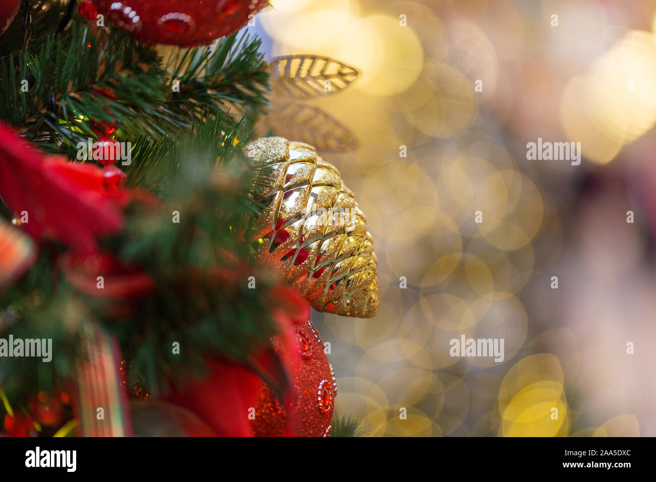 Christmas toys on Christmas tree with lights on background. Festive decoration, space for text Stock Photo