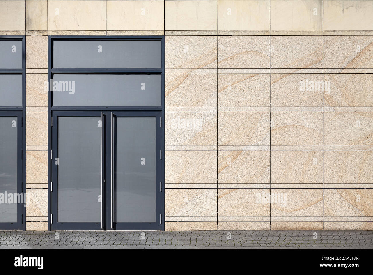 Front view of a building wall with closed door. Stock Photo