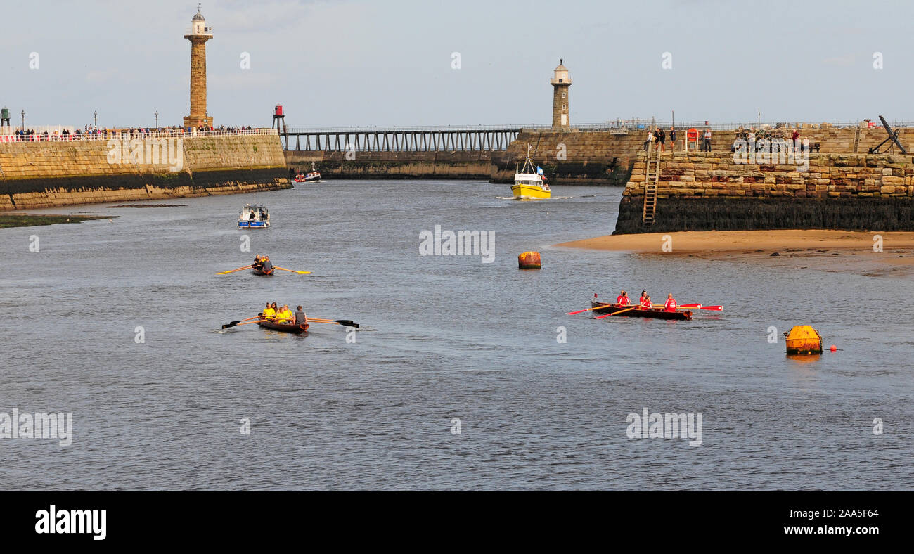 Rowing boats on the river Esk, rowing out of Whitby Harbour Stock Photo