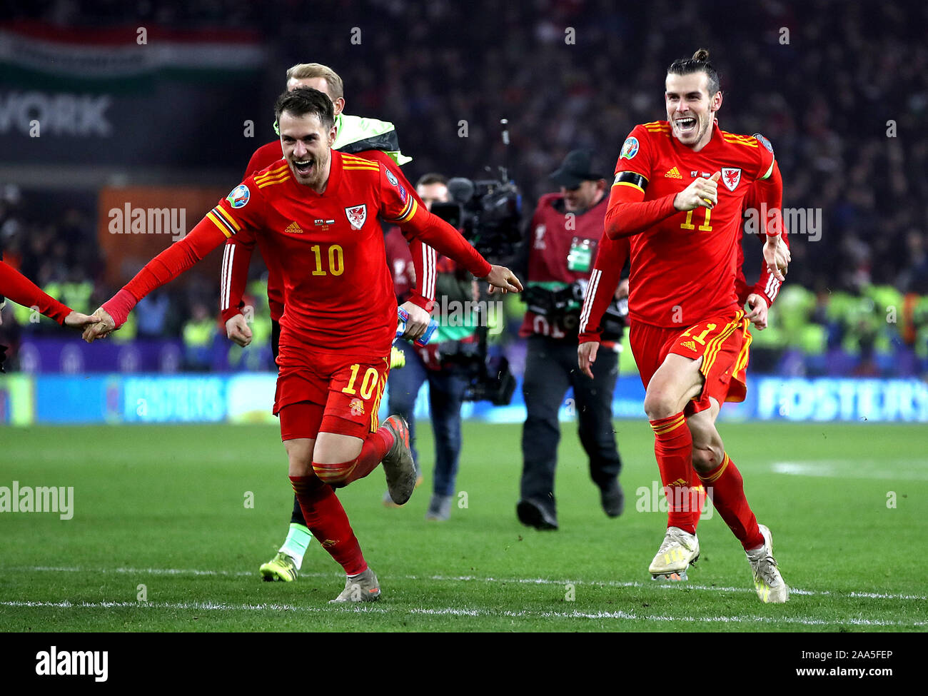 Wales' Aaron Ramsey (left) and Gareth Bale (right) celebrate victory an qualification after the final whistle during the UEFA Euro 2020 Qualifying match at the Cardiff City Stadium. Stock Photo