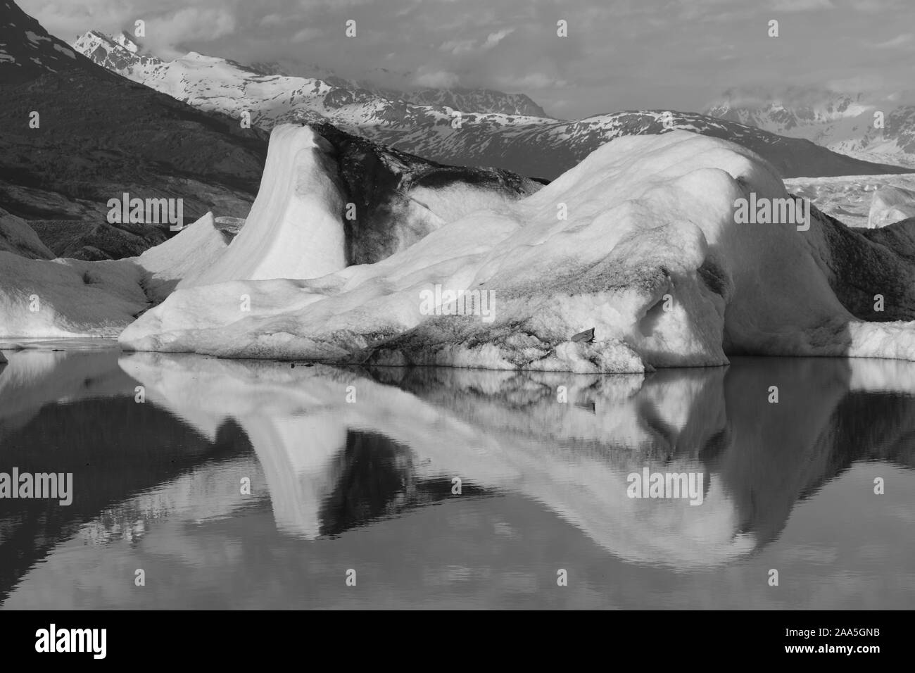 Black and white photo of Icebergs floating in the Knik Glacier lagoon, Chugach Mountains, Alaska Stock Photo