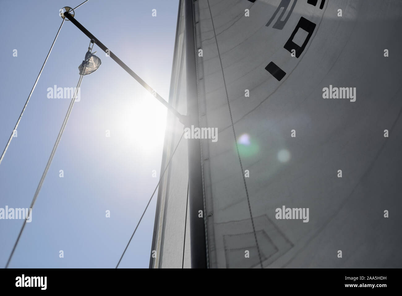 Sailing sailboat yacht sail with sunlight flare and sign label marking