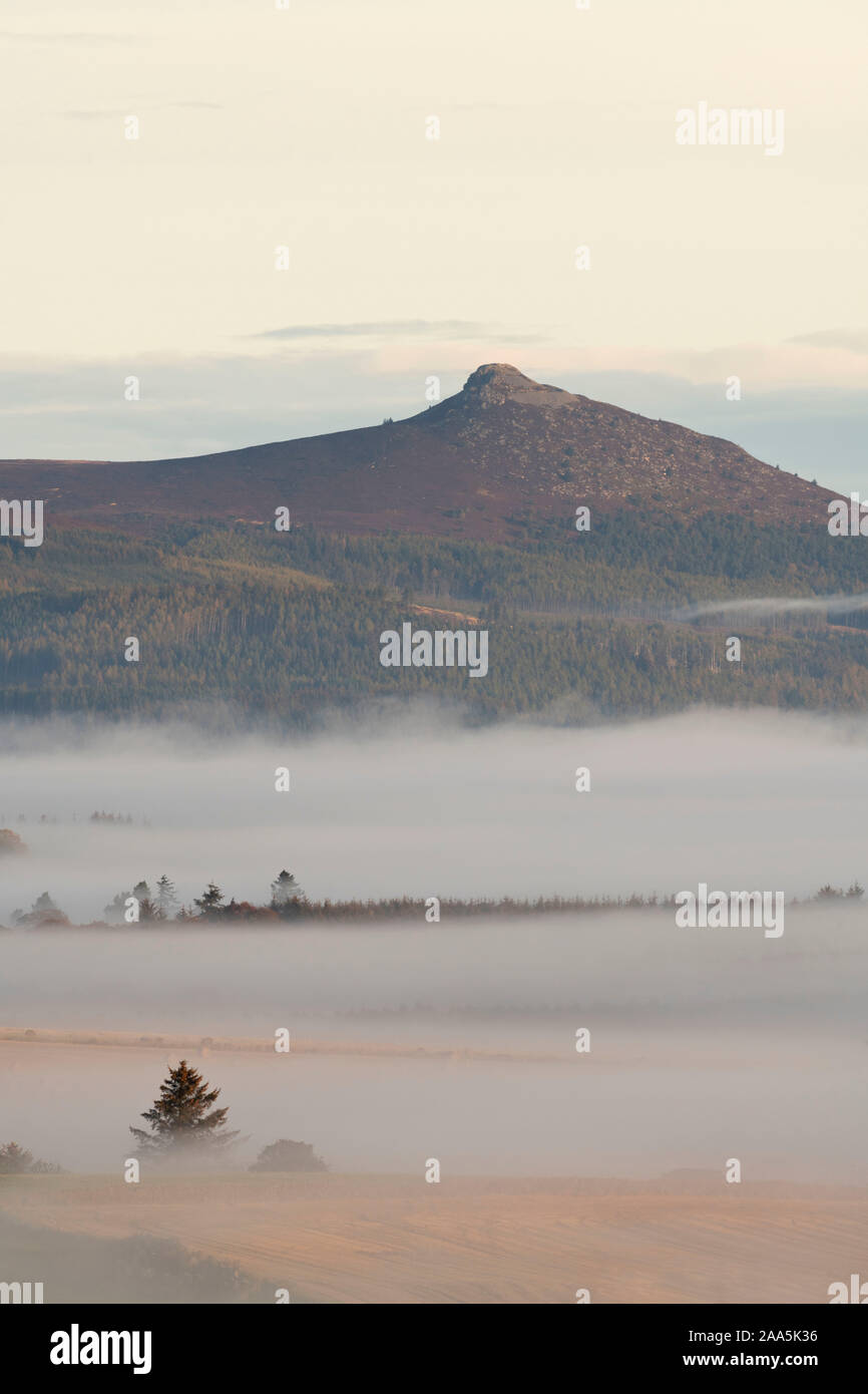 A View Across Misty Farmland Towards Bennachie on an Autumnal Morning in Aberdeenshire Stock Photo