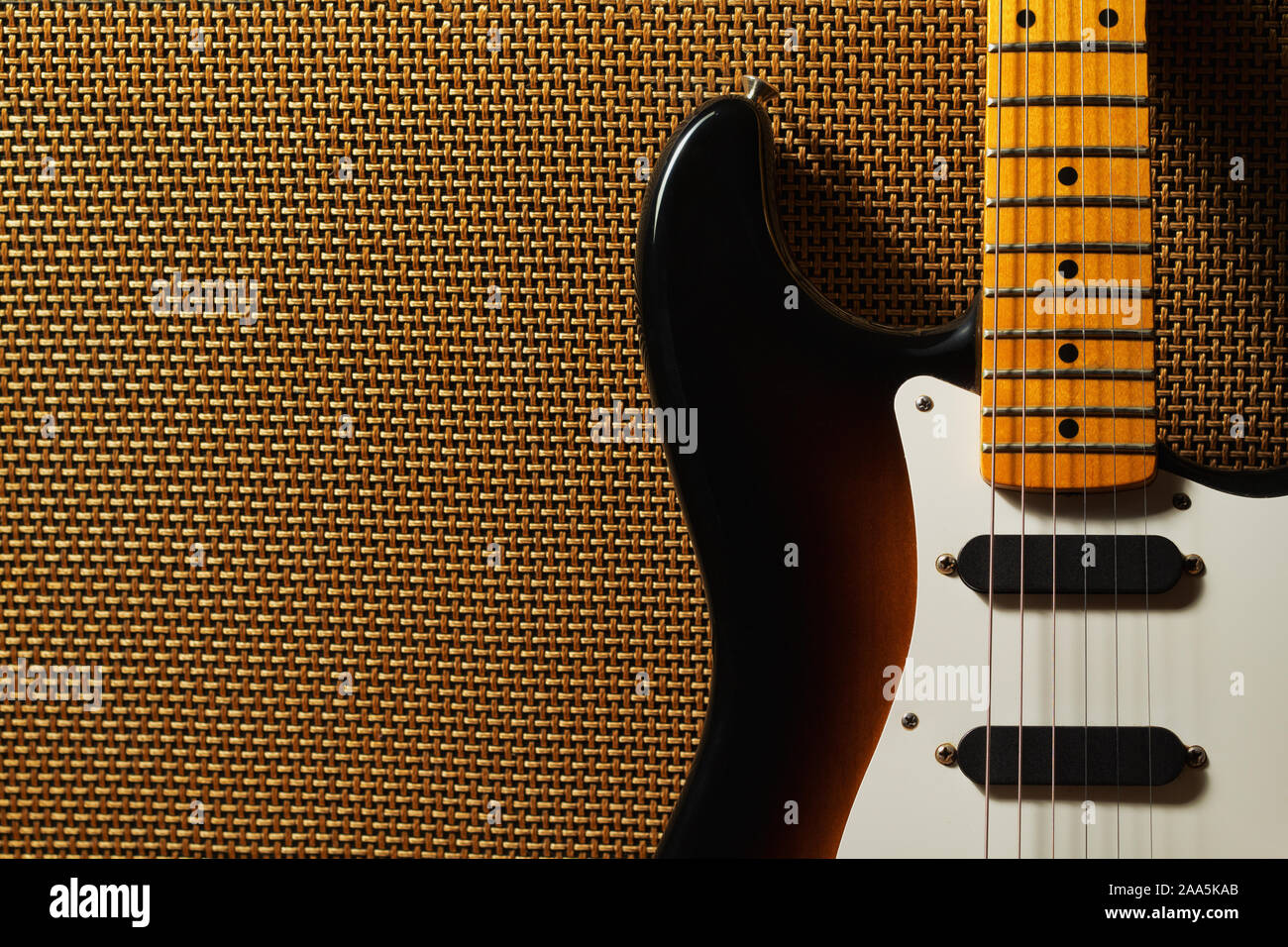 Electric guitar and amplifier grill in stage lighting Stock Photo