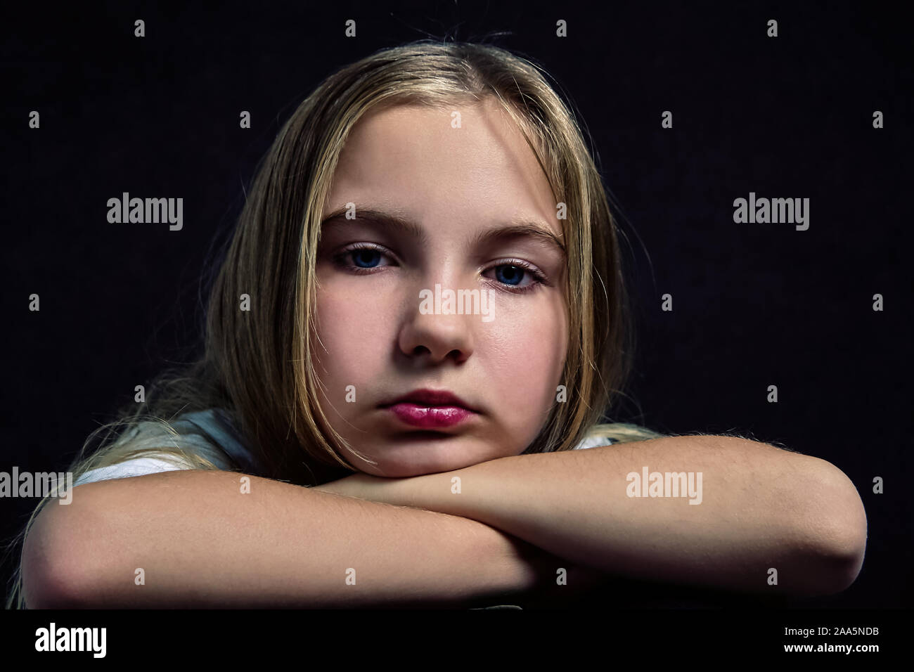 Portrait of a cute pensive teenage girl with long hair. Pretty woman face close up portrait with healthy skin. Stock Photo