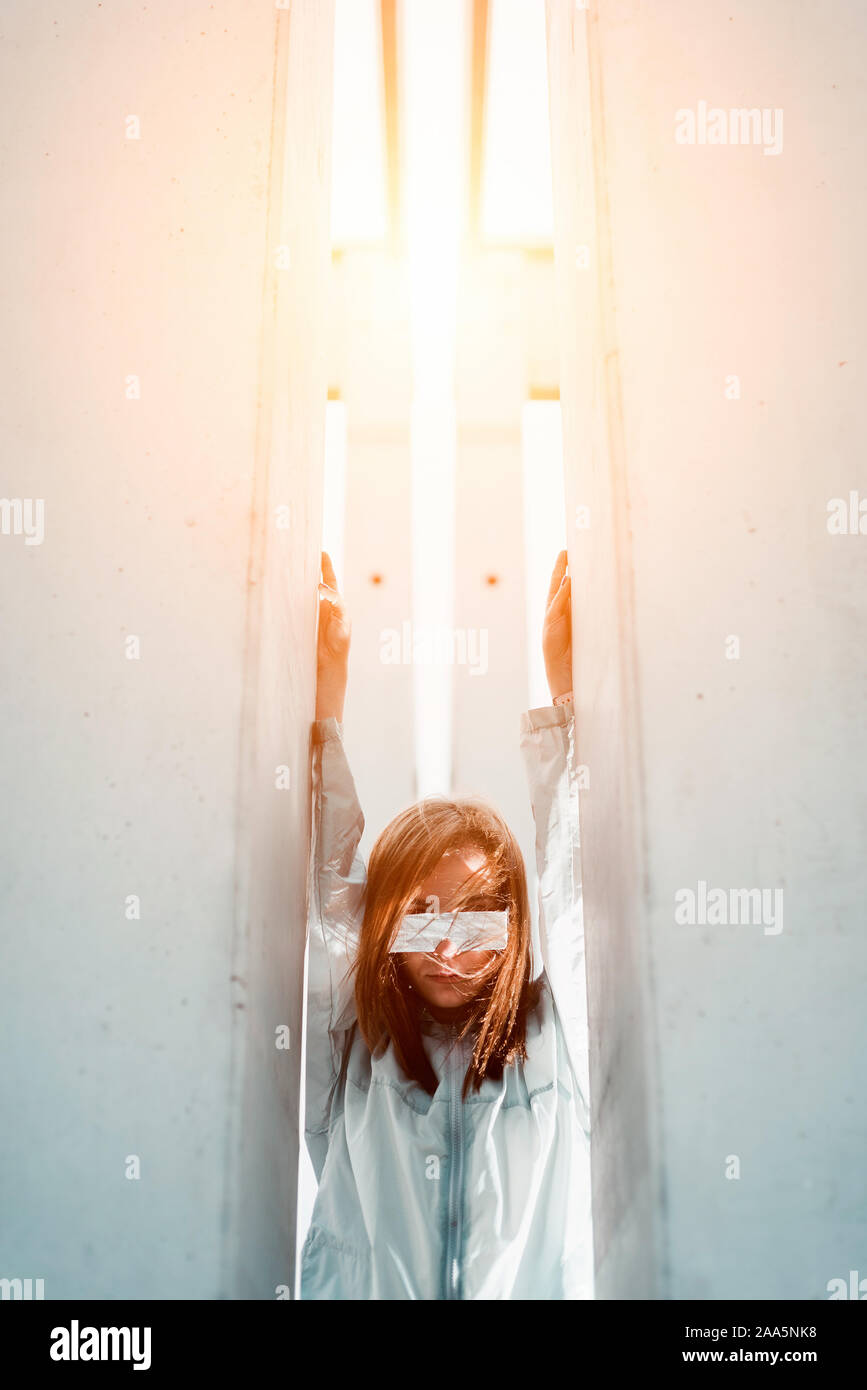 Young woman between white walls portrait, futuristic concept Stock Photo