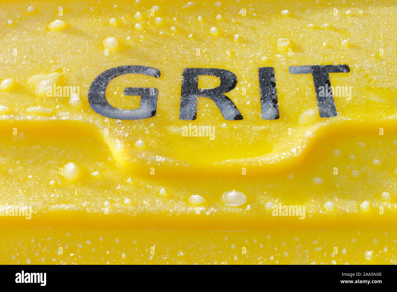 A yellow grit bin that has frozen over. Stock Photo